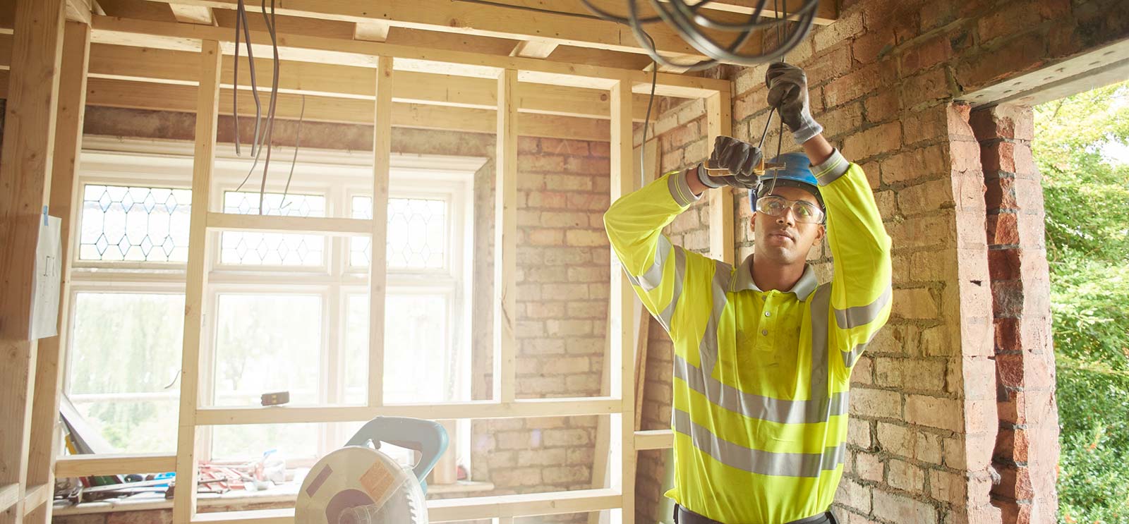 Electrician working on wiring in new house