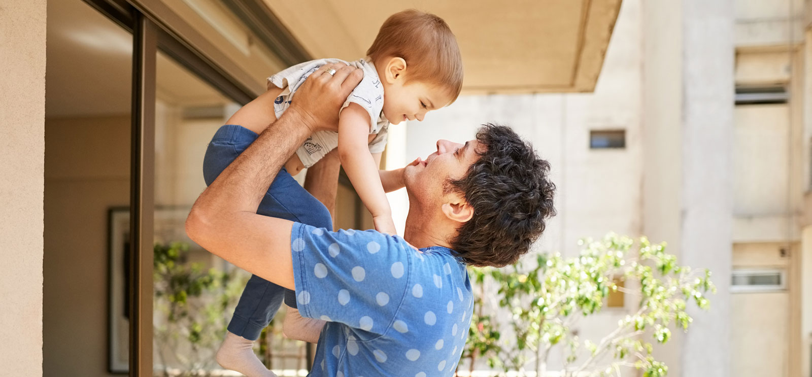 Father and son playing on back porch